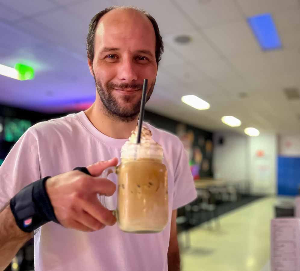 Ndis participant enjoying a milkshake at the logan city bowling ally